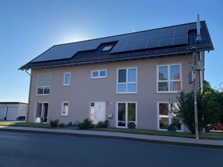 Haus „Zum Linderfeld" Modernes, zweigeschossiges Haus mit Solaranlage und großen Fenstern.